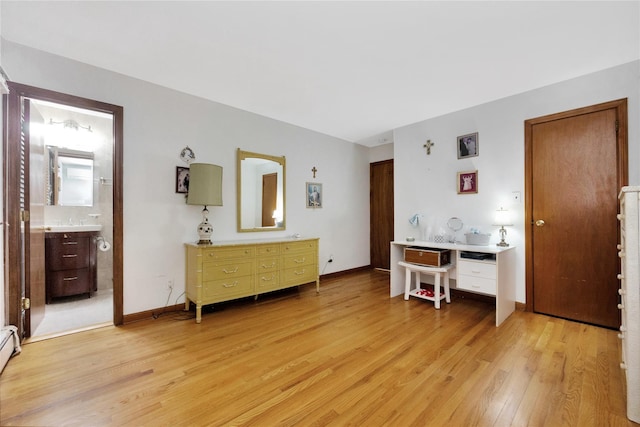 64 Church St, Syosset, NY 11791 - bedroom featuring light wood-style floors, baseboard heating, and baseboards