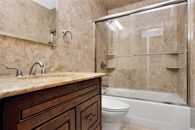 64 Church St, Syosset, NY 11791 - full bath featuring toilet, vanity, tile walls, shower / bath combination with glass door, and tasteful backsplash