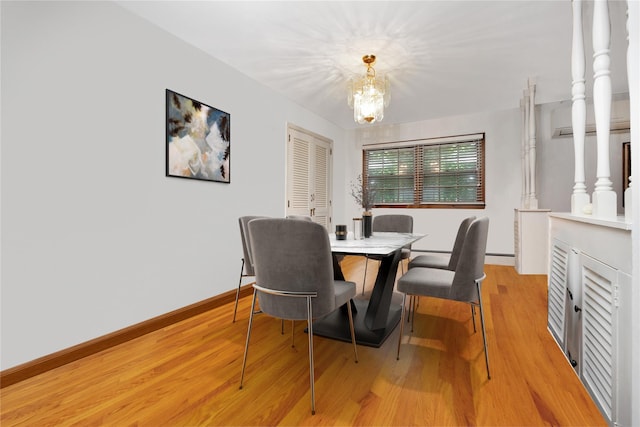 64 Church St, Syosset, NY 11791 - dining room featuring a chandelier, light wood-style flooring, and baseboards