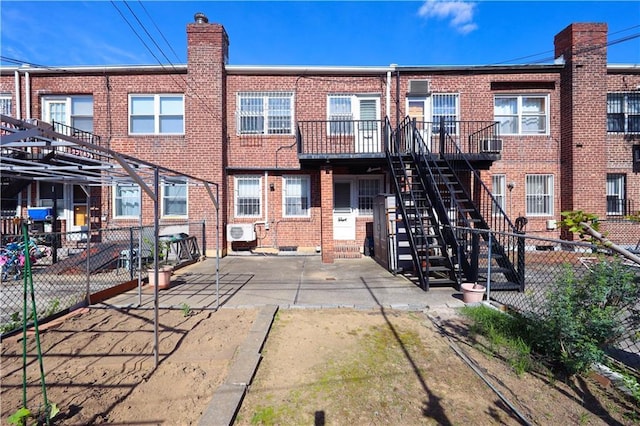 2366 E 29th St, Brooklyn, NY 11229 - rear view of property featuring brick siding, stairs, a patio, and a cooling unit