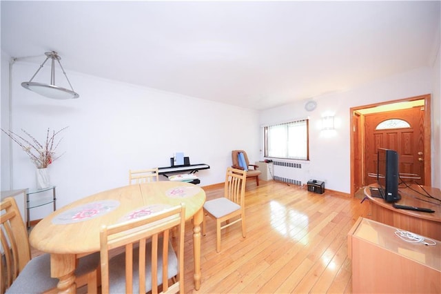 2366 E 29th St, Brooklyn, NY 11229 - dining space with radiator heating unit and light wood-style floors