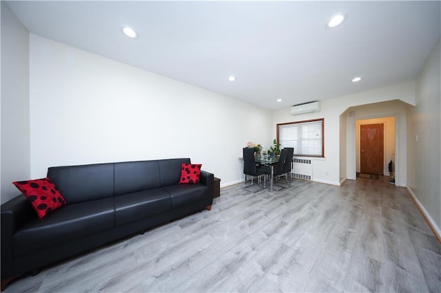 2366 E 29th St, Brooklyn, NY 11229 - living room with wood finished floors, a wall mounted AC, recessed lighting, radiator, and baseboards