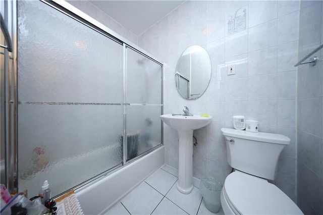 2366 E 29th St, Brooklyn, NY 11229 - full bathroom featuring toilet, tile patterned floors, shower / bath combination with glass door, tile walls, and a sink