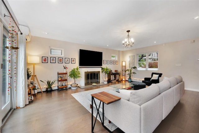 13915 Coolidge Ave, Briarwood, NY 11435 - living area featuring wood finished floors, a chandelier, a glass covered fireplace, recessed lighting, and an AC wall unit