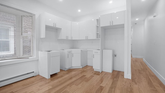 2825 Wellman Ave, Bronx, NY 10461 - kitchen with baseboard heating, white cabinets, light wood-style floors, modern cabinets, and recessed lighting