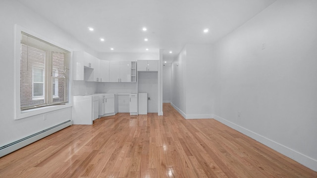 2825 Wellman Ave, Bronx, NY 10461 - unfurnished living room featuring a baseboard radiator, light wood finished floors, baseboards, and recessed lighting