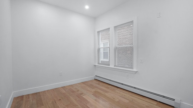 2825 Wellman Ave, Bronx, NY 10461 - spare room with a baseboard heating unit, light wood-style flooring, baseboards, and recessed lighting
