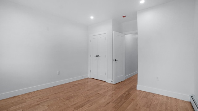 2825 Wellman Ave, Bronx, NY 10461 - unfurnished room with baseboards, light wood finished floors, recessed lighting, and a baseboard heating unit