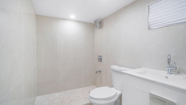 2825 Wellman Ave, Bronx, NY 10461 - bathroom featuring toilet, tiled shower, tile walls, and vanity