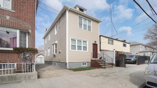 2825 Wellman Ave, Bronx, NY 10461 - view of front of house with concrete driveway, an outdoor structure, and a detached garage