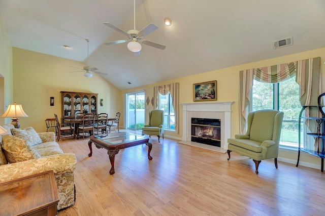 276 Dockside Ct, Moriches, NY 11955 - living room with ceiling fan, vaulted ceiling, a tile fireplace, light wood finished floors, and baseboards