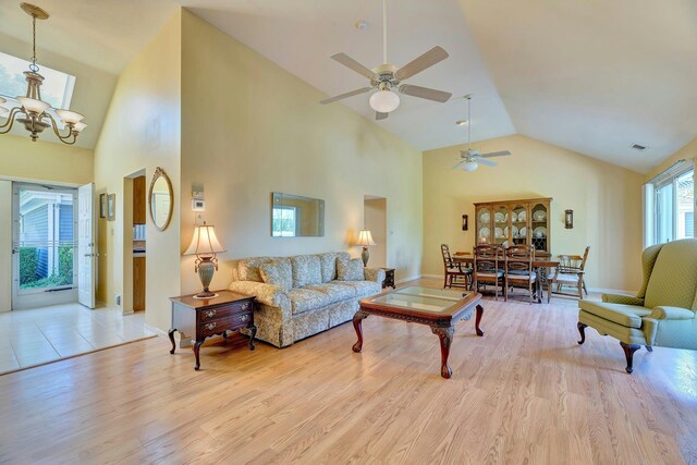 276 Dockside Ct, Moriches, NY 11955 - living area featuring ceiling fan, high vaulted ceiling, wood finished floors, a chandelier, and baseboards
