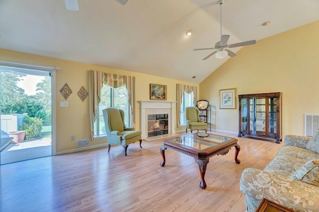 276 Dockside Ct, Moriches, NY 11955 - living area featuring ceiling fan, light wood-style floors, high vaulted ceiling, baseboards, and a tiled fireplace