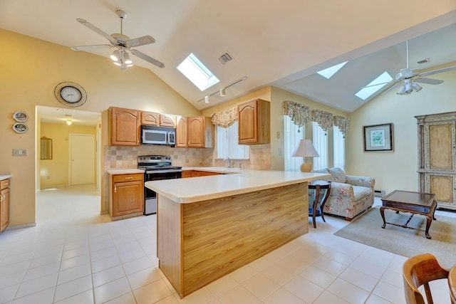 276 Dockside Ct, Moriches, NY 11955 - kitchen featuring a skylight, stainless steel appliances, a ceiling fan, a sink, and high vaulted ceiling