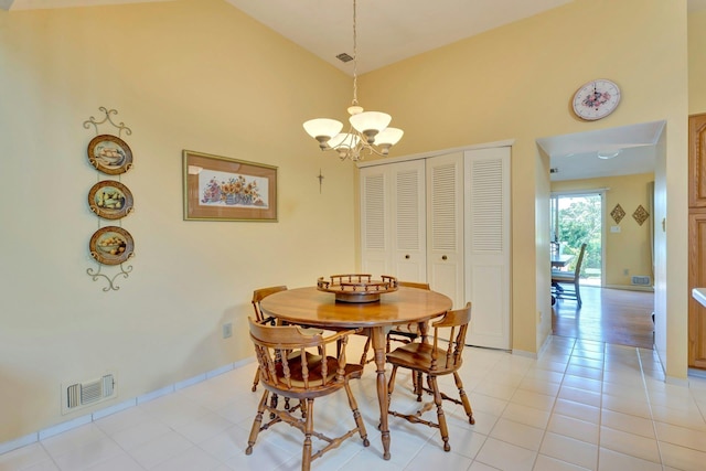 276 Dockside Ct, Moriches, NY 11955 - dining area featuring a chandelier, a high ceiling, light tile patterned flooring, and baseboards