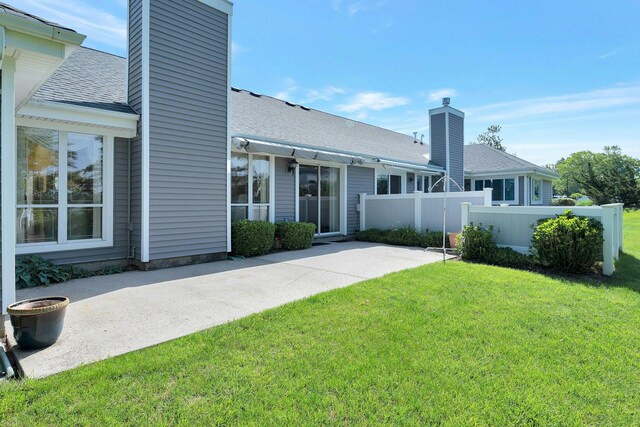276 Dockside Ct, Moriches, NY 11955 - rear view of house with a chimney and roof with shingles