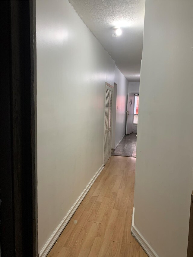 199 Lincoln Ave, Brooklyn, NY 11208 - hallway with light wood-style floors and a textured ceiling