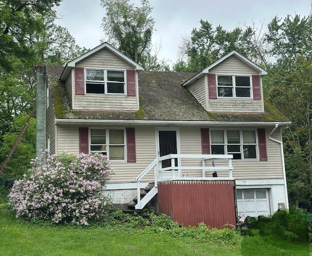 95 Smithtown Rd, Fishkill, NY 12524 - view of front of house with a garage and a chimney