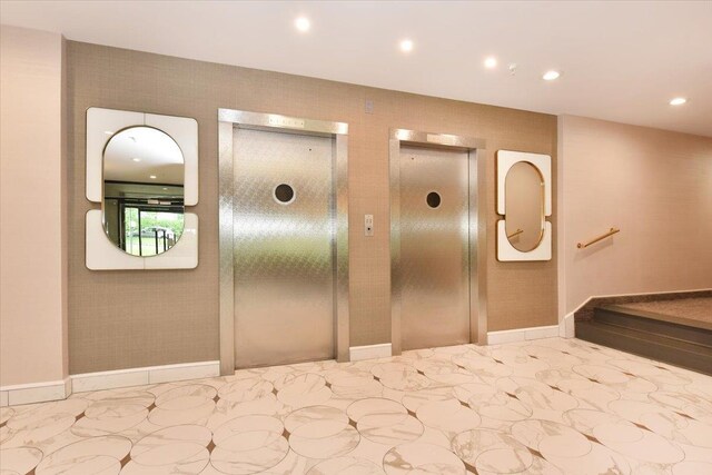 40 Stoner Ave Unit 1-I, Great Neck, NY 11021 - corridor with elevator, recessed lighting, baseboards, and marble finish flooring