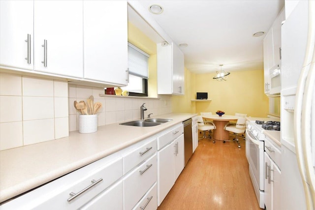 40 Stoner Ave Unit 1-I, Great Neck, NY 11021 - kitchen featuring white appliances, a sink, white cabinets, and light wood-type flooring