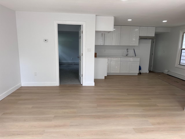 19 N Rd, Highland, NY 12528 - kitchen with a sink, white cabinets, baseboards, a baseboard heating unit, and recessed lighting
