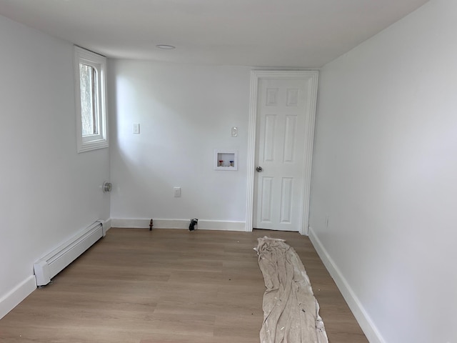 19 N Rd, Highland, NY 12528 - washroom with baseboard heating, washer hookup, light wood-style floors, and baseboards