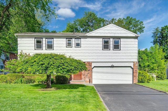 71 Harlan Dr, New Rochelle, NY 10804 - view of front facade featuring brick siding, an attached garage, driveway, and a front yard