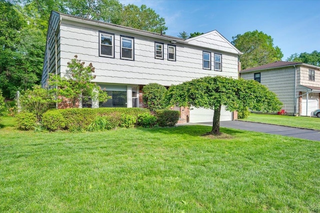 71 Harlan Dr, New Rochelle, NY 10804 - view of front of property featuring asphalt driveway, an attached garage, and a front yard