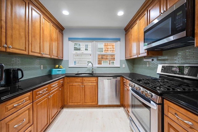 71 Harlan Dr, New Rochelle, NY 10804 - kitchen with stainless steel appliances, brown cabinets, dark stone countertops, and recessed lighting