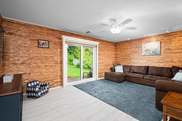 71 Harlan Dr, New Rochelle, NY 10804 - living area featuring ceiling fan, rail lighting, wood finished floors, and wooden walls