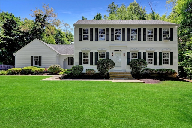 14 Wainscott Ln, East Setauket, NY 11733 - colonial house featuring a front lawn, entry steps, and a shingled roof
