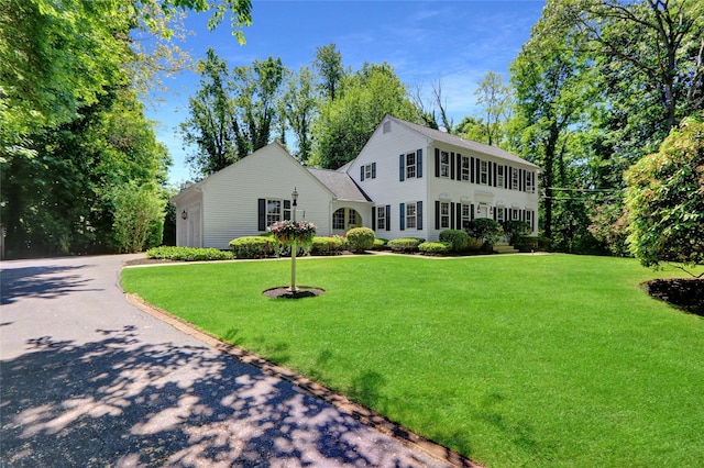 14 Wainscott Ln, East Setauket, NY 11733 - colonial home with a front yard, asphalt driveway, and roof with shingles