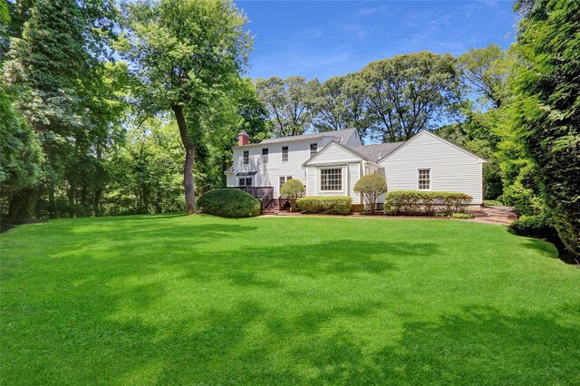 14 Wainscott Ln, East Setauket, NY 11733 - view of front of home featuring a front yard and a chimney
