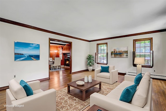 14 Wainscott Ln, East Setauket, NY 11733 - living area featuring healthy amount of natural light, wood finished floors, ornamental molding, and baseboards