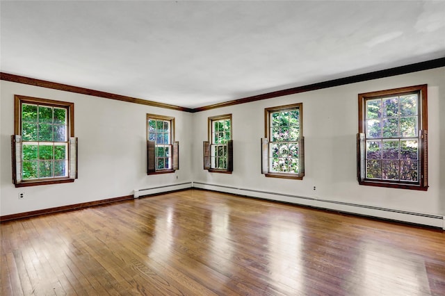 14 Wainscott Ln, East Setauket, NY 11733 - empty room with hardwood / wood-style flooring, healthy amount of natural light, ornamental molding, baseboards, and a baseboard radiator