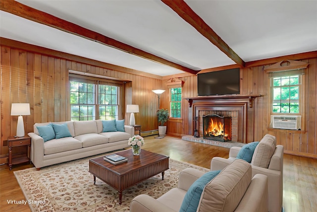 14 Wainscott Ln, East Setauket, NY 11733 - living area with beamed ceiling, healthy amount of natural light, a brick fireplace, wood walls, and wood finished floors