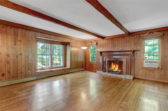 14 Wainscott Ln, East Setauket, NY 11733 - unfurnished living room with beamed ceiling, hardwood / wood-style flooring, a brick fireplace, plenty of natural light, and a baseboard heating unit
