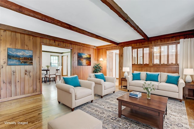 14 Wainscott Ln, East Setauket, NY 11733 - living area featuring wood walls, beam ceiling, and light wood-style flooring