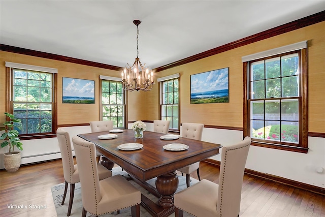 14 Wainscott Ln, East Setauket, NY 11733 - dining room featuring hardwood / wood-style floors, a chandelier, healthy amount of natural light, baseboards, and ornamental molding