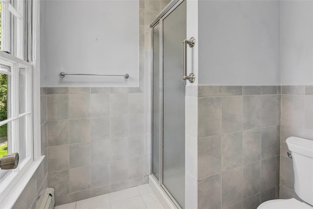 14 Wainscott Ln, East Setauket, NY 11733 - bathroom with tile walls, toilet, a stall shower, tile patterned flooring, and wainscoting