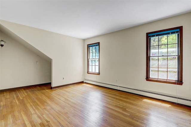 14 Wainscott Ln, East Setauket, NY 11733 - empty room with a baseboard radiator, plenty of natural light, light wood-style floors, and baseboards