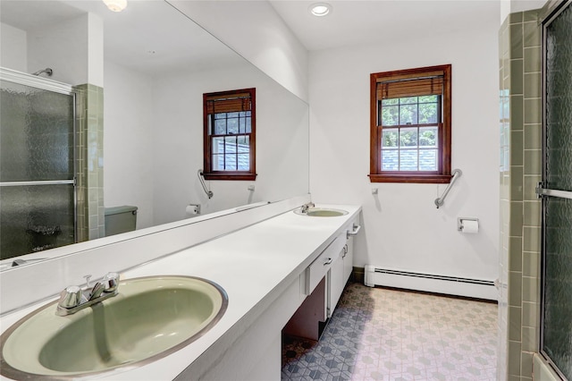 14 Wainscott Ln, East Setauket, NY 11733 - bathroom with a baseboard heating unit, healthy amount of natural light, double vanity, a shower with shower door, and recessed lighting