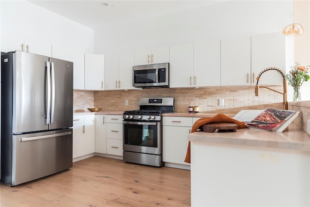 249 Main St Unit 401, Beacon, NY 12508 - kitchen featuring stainless steel appliances, light countertops, white cabinetry, and light wood-type flooring