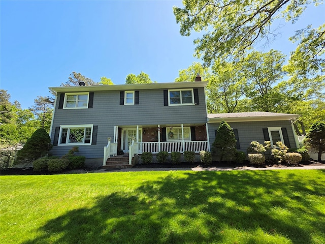 81 Anchor St, Riverhead, NY 11901 - colonial inspired home featuring covered porch, a chimney, and a front yard