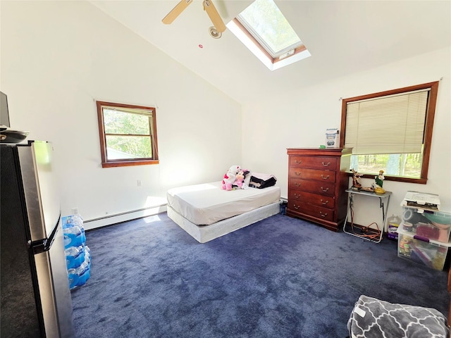 81 Anchor St, Riverhead, NY 11901 - bedroom featuring baseboard heating, freestanding refrigerator, a skylight, lofted ceiling, and dark carpet