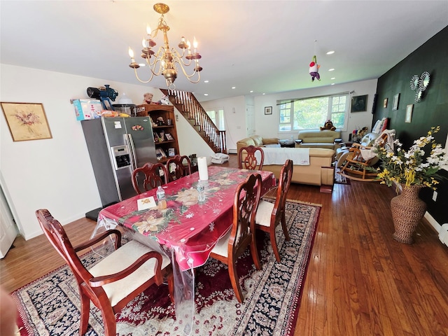 81 Anchor St, Riverhead, NY 11901 - dining area featuring a chandelier, wood-type flooring, recessed lighting, and stairway