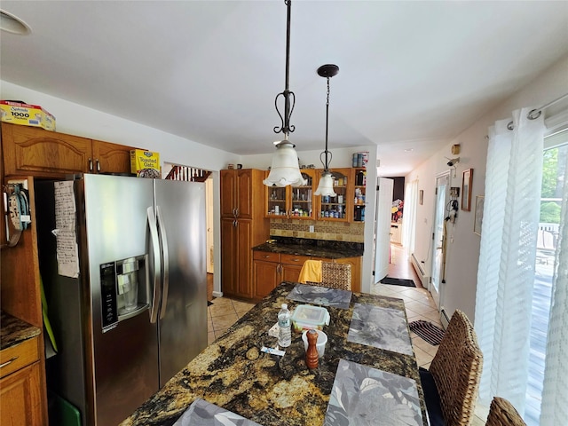 81 Anchor St, Riverhead, NY 11901 - kitchen featuring stainless steel fridge with ice dispenser, light tile patterned flooring, glass insert cabinets, and brown cabinetry