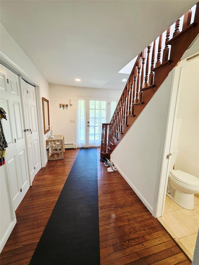 81 Anchor St, Riverhead, NY 11901 - entrance foyer with recessed lighting, stairs, wood finished floors, a baseboard radiator, and baseboards