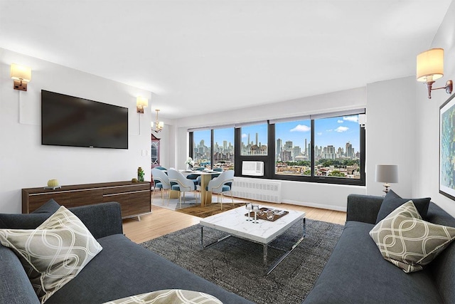 33-43 14th St Unit 12B, Astoria, NY 11106 - living room featuring wood finished floors and radiator heating unit