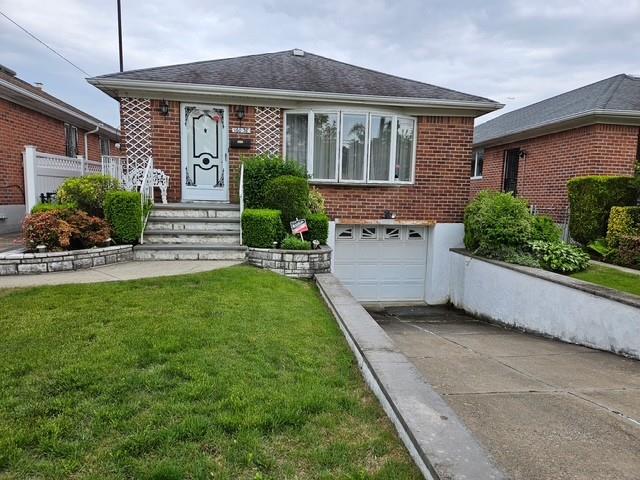160-38 23rd Ave, Whitestone, NY 11357 - view of front of property featuring concrete driveway, brick siding, an attached garage, and a front yard